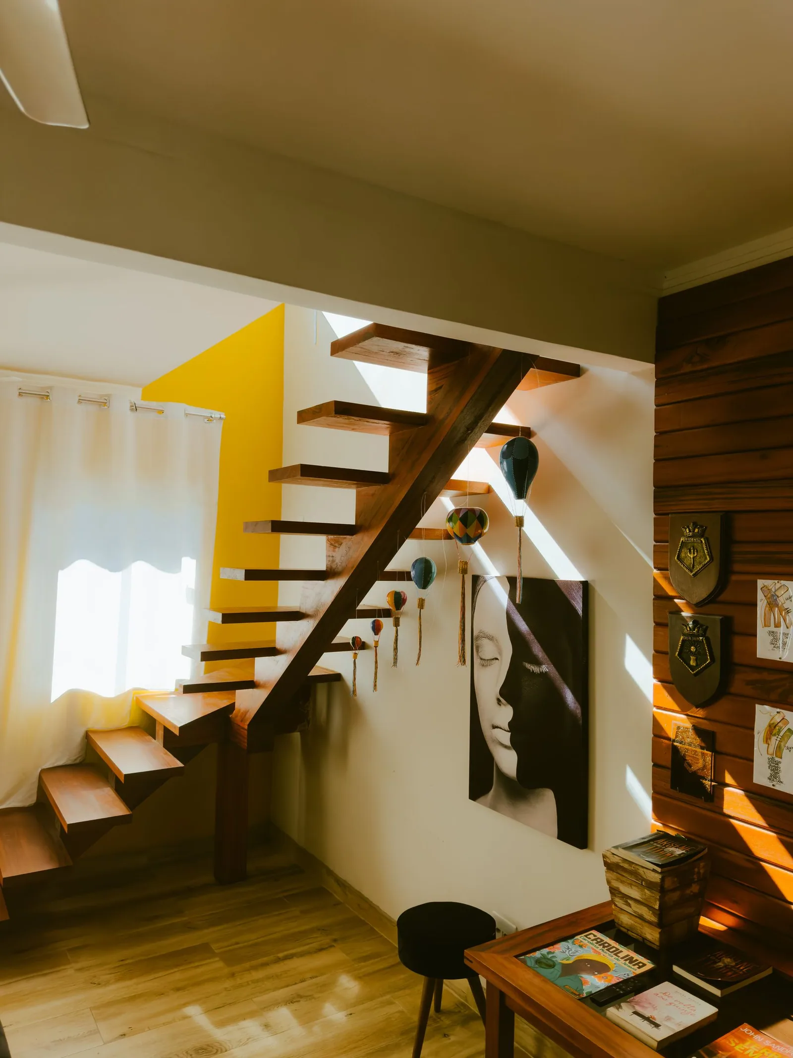 A wooden staircase in a sunlit house