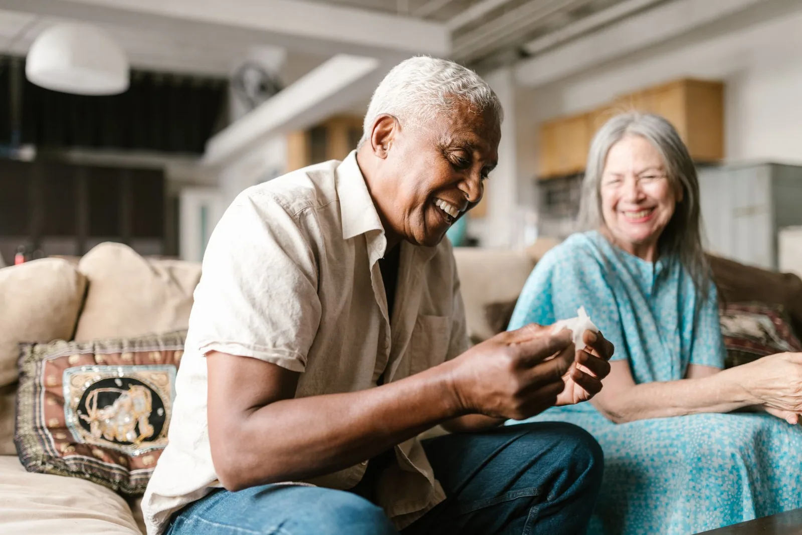 A couple laughing in their living room