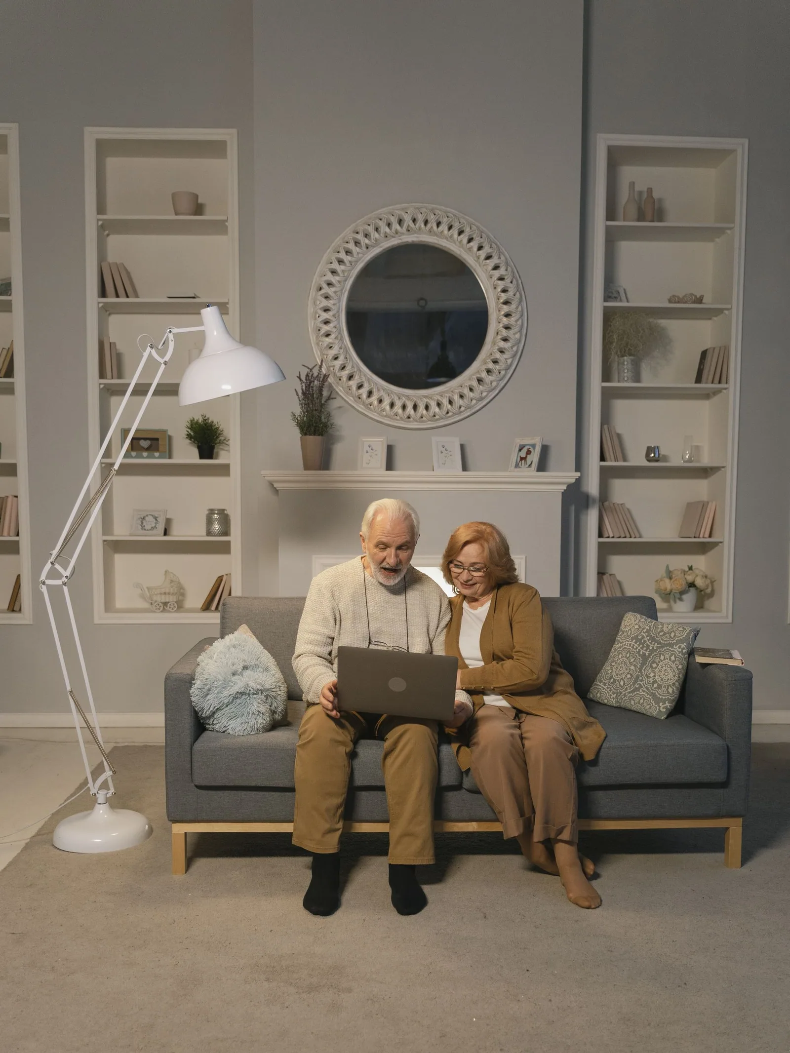 Two people at home with a laptop