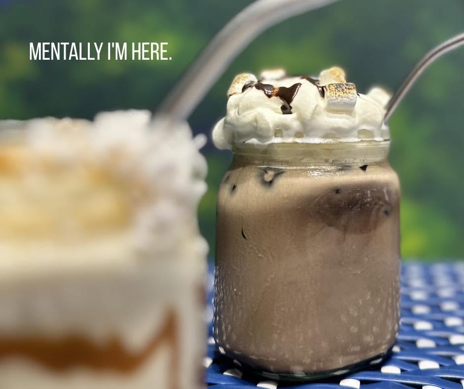 Iced mocha in a glass jar with whipped cream and toasted marshmallows