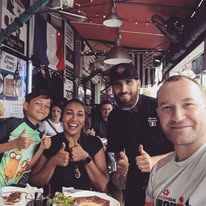 Staff and guests together inside the shop, smiling for a photograph