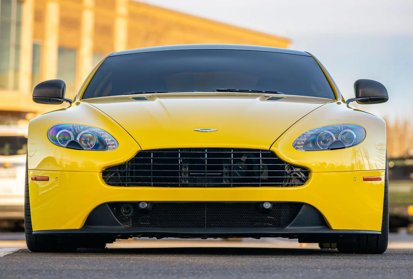 A yellow Aston Martin sports car